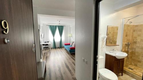 a bathroom with a toilet and a sink and a room at Sorriso Mamaia Nord in Mamaia Nord