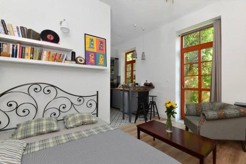 a bedroom with a bed and a living room at Castle hill garden studio in Budapest
