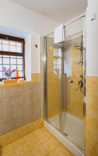 a bathroom with a shower with a glass door at Carmine House in Monreale