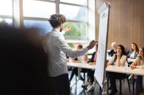 a man giving a presentation in front of a group of people at lintharena ag in Näfels