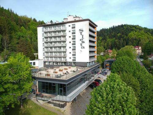 a large building with a sign on top of it at Silesia Krynica in Krynica Zdrój