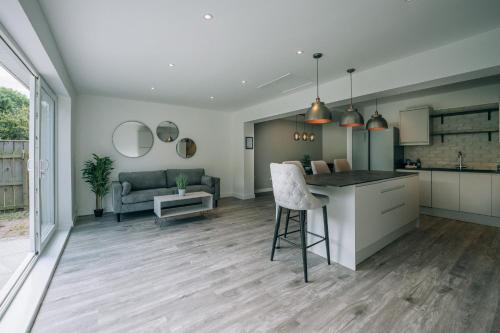 a kitchen and living room with a counter and a table at Wiske House Free Parking & Fast WiFi in Stockton-on-Tees