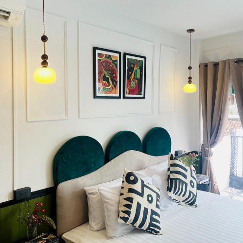 a bedroom with a bed and blue chairs at Isara Boutique Hotel and Cafe in Phuket Town