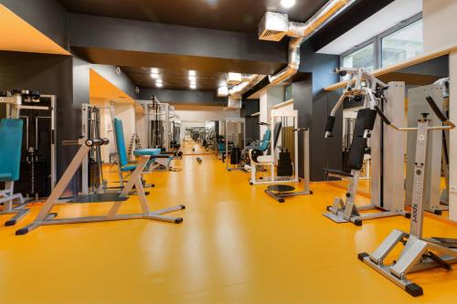 a gym with several treadmills and machines at Silesia Krynica in Krynica Zdrój