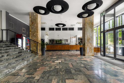 a lobby of a building with large windows at Silesia Krynica in Krynica Zdrój
