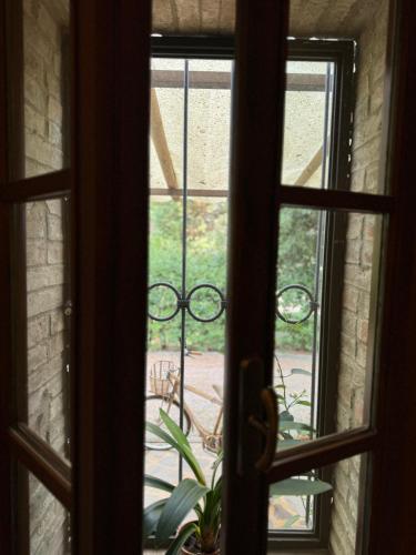 an open window looking out at a patio outside at B&B Podere Cottimellino - Montalcino - Val d'Orcia in Montalcino