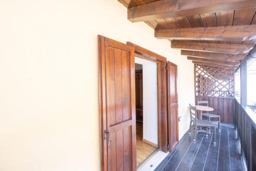 an open door to a balcony with a table and chair at Residence Desiree in Riva del Garda
