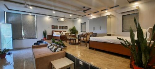 a large room with a bed and a living room at Meeram Ganga, A Heritage Stay by the Ganges at Triveni Ghat in Rishīkesh