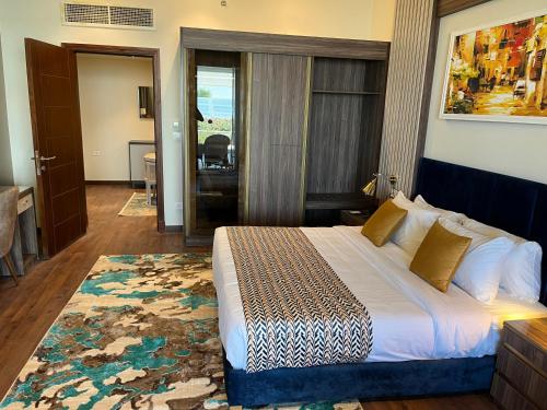 a bedroom with a large bed with a rug at Tolip Resort El Galala Heights in Ain Sokhna
