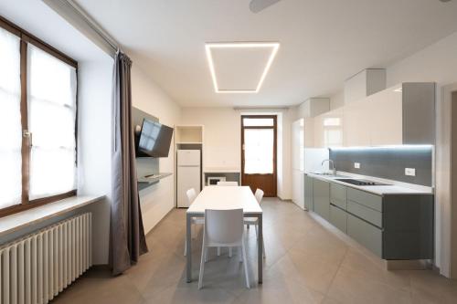 a kitchen with a white table and a white counter top at Residence Desiree in Riva del Garda