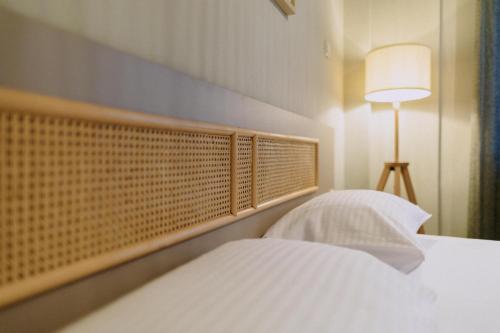 a bedroom with a bed with a lamp and a white bed sidx sidx at Anassa House in Alexandroupoli