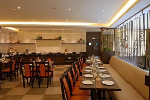 a restaurant with tables and chairs and a bar at Grand Continent - Bangalore International Airport in Devanahalli-Bangalore