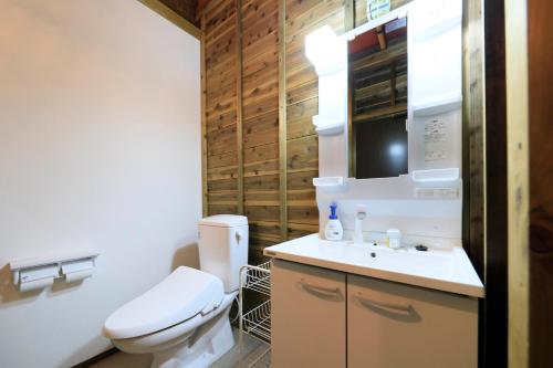 a bathroom with a toilet and a sink at リバウッドリゾート in Mori