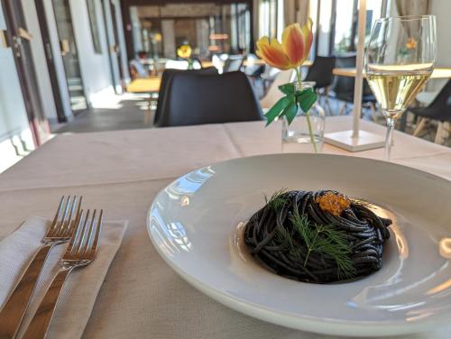 a plate of food on a table with fork and knife at Hotel Ristorante Magia del Brenta in Fiesso dʼArtico