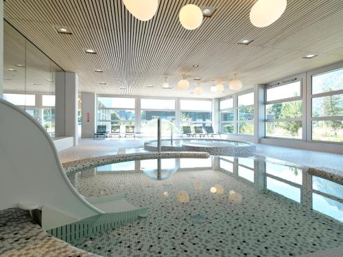 a swimming pool with a slide in a building at lintharena ag in Näfels