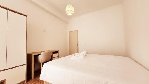 a white bedroom with a bed and a mirror at Rooms4you 1 in historic center of Braga in Braga