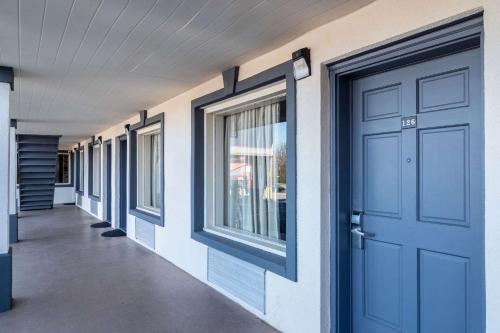 a row of windows and a door on a building at Econo Lodge Calhoun North Damascus in Calhoun