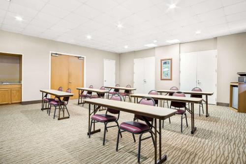 a classroom with tables and chairs in a room at Comfort Inn Gold Coast in Ocean City