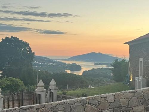a view of a lake from a house at Oliveiral Villa with River View, Heated Pool & Jacuzzi in Vila Nova de Cerveira