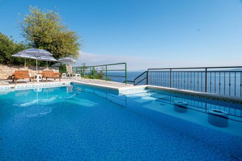 a swimming pool with a view of the ocean at Apartments with pool Maraska in Brela