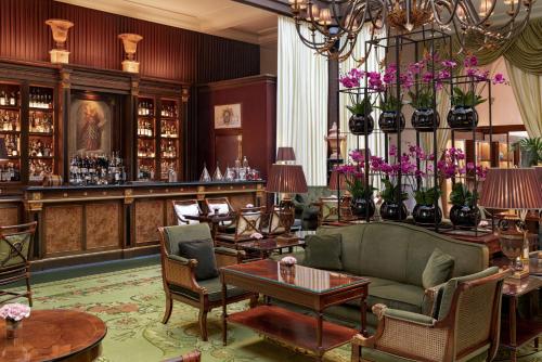 a lobby with a couch and chairs and a bar at Four Seasons Hotel Firenze in Florence
