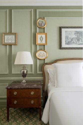 a bedroom with a bed and a table with a lamp at Four Seasons Hotel Firenze in Florence