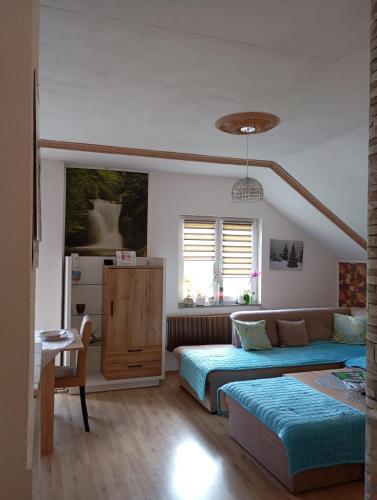 a bedroom with two beds and a refrigerator at Apartman Denis Una in Lužine