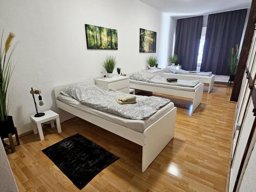 a room with two beds in a room at Workers Apartments Satzvey in Satzvey