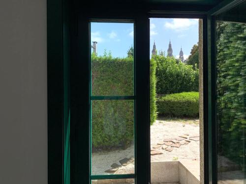 an open window with a view of a garden at Hotel Pombal Rooms in Santiago de Compostela
