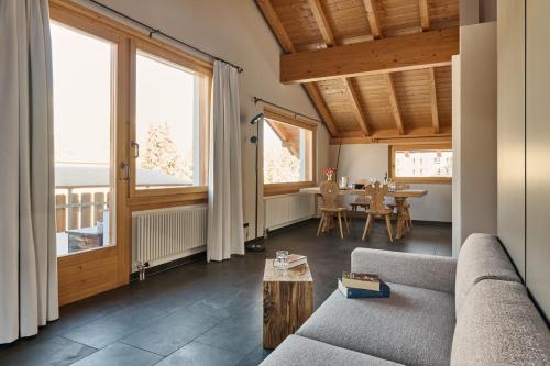a living room with a couch and a table at Chesa Madrisa in St. Moritz