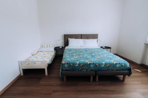 a bedroom with a bed and a night stand next to it at Sleep & Fly Villa Luisa in Case Nuove
