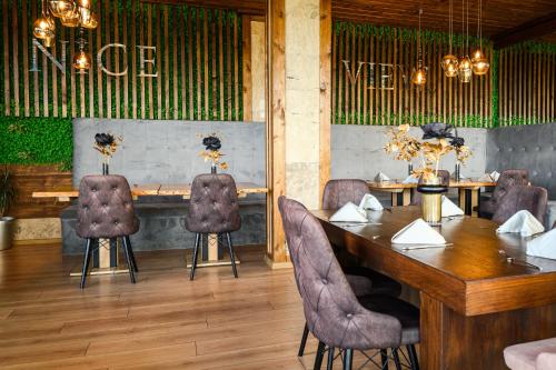 a dining room with a wooden table and chairs at Katalina SPA Resort in Tsigov Chark