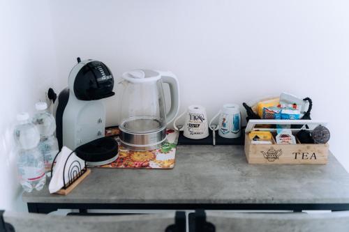a counter top with a mixer and other kitchen items at Sleep & Fly Villa Luisa in Case Nuove