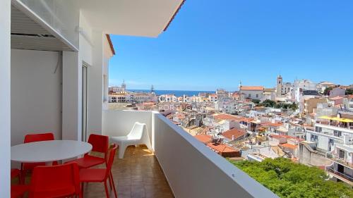 a balcony with a table and chairs and a view at Rooftop - Perto da Praia - 6 Pax - Albufeira in Albufeira