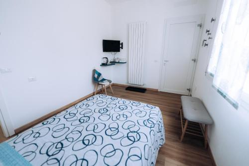 a bedroom with a bed and a chair in it at Sleep & Fly Villa Luisa in Case Nuove