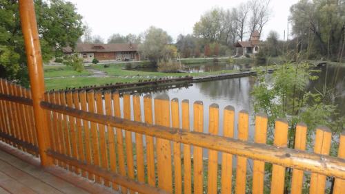a fence with a view of a river at Resort Svět in Úžice