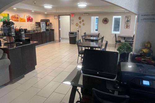 a restaurant with a table and chairs and a kitchen at Quality Inn Raton, NM in Raton