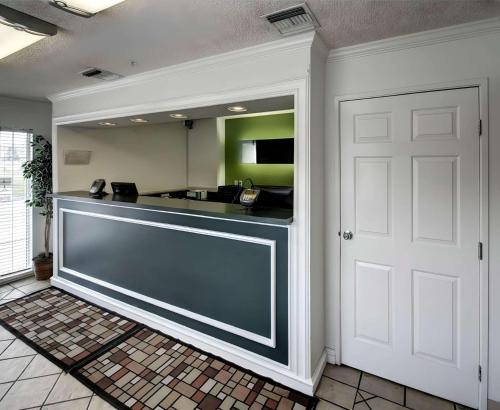 a lobby with a counter and a white door at Studio 6 - Murray, UT in Murray