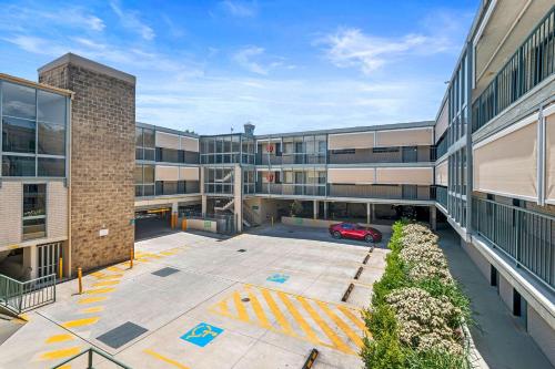 an empty parking lot in front of a building at Quality Inn Sunshine Haberfield in Sydney