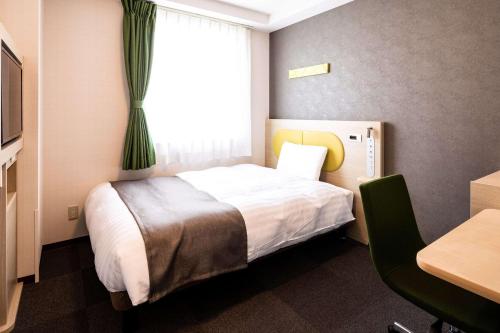 a hotel room with a bed and a window at Comfort Hotel Kochi in Kochi