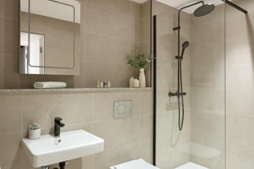 a bathroom with a shower and a sink at London City East by Viridian Apartments in London