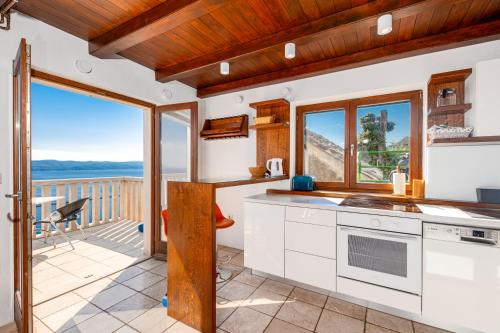 a kitchen with a view of the ocean at Apartments with pool Maraska in Brela