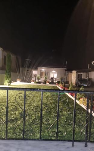 a backyard at night with a fence at Kariofilli's house in Áyios Athanásios