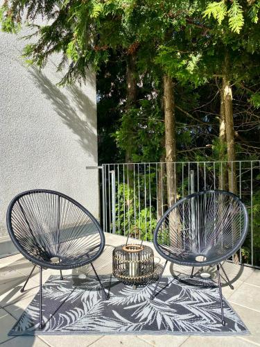two metal chairs and a basket on a patio at Stilvolles Appartement in Jena