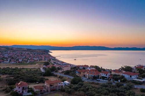 an aerial view of a city and the water at Anima Residence in Nea Roda