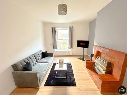 a living room with a couch and a fireplace at Modern 1 Bed Apartment In Morpeth - Contractors in Morpeth