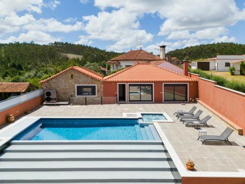 a villa with a swimming pool and a house at Casa do Moleiro in Mortágua