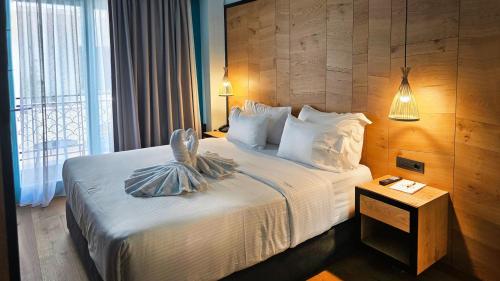a hotel room with a bed and a window at Artion Boutique by Enorme in Heraklio Town