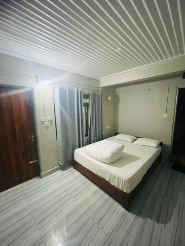 a bedroom with a large bed in a room at Deurali Guest House in Pokhara