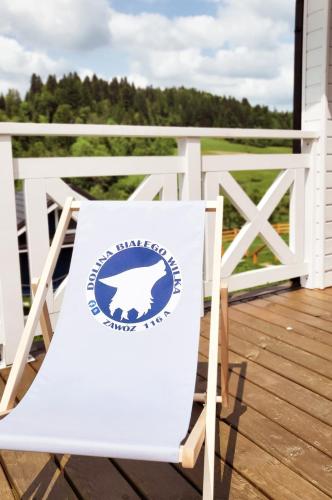 a sign on a chair on a porch at Dolina Białego Wilka - Niebieskie Domki in Zawóz